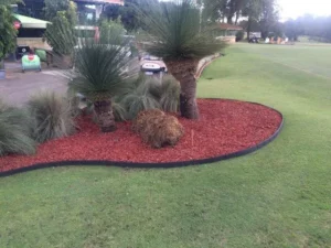 Flower-filled garden bed framed by Enviro Blocks