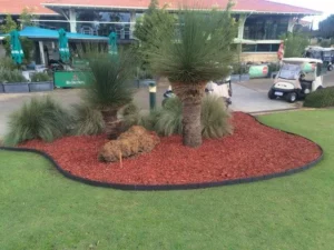 Flower-filled garden bed framed by Enviro Blocks