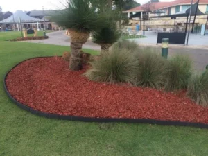 Flower-filled garden bed framed by Enviro Blocks