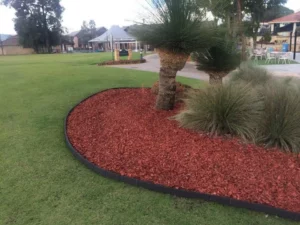 Flower-filled garden bed framed by Enviro Blocks